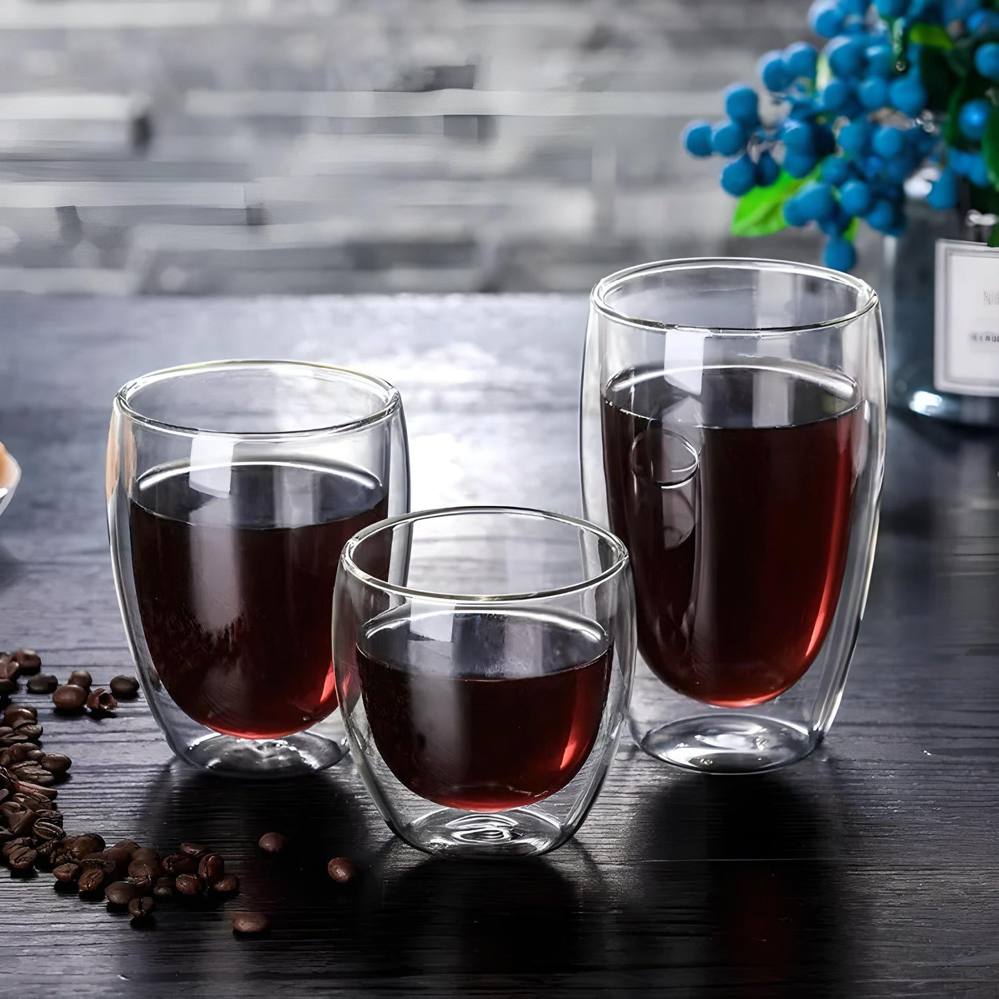 Three double wall glasses in different sizes with black coffee in them