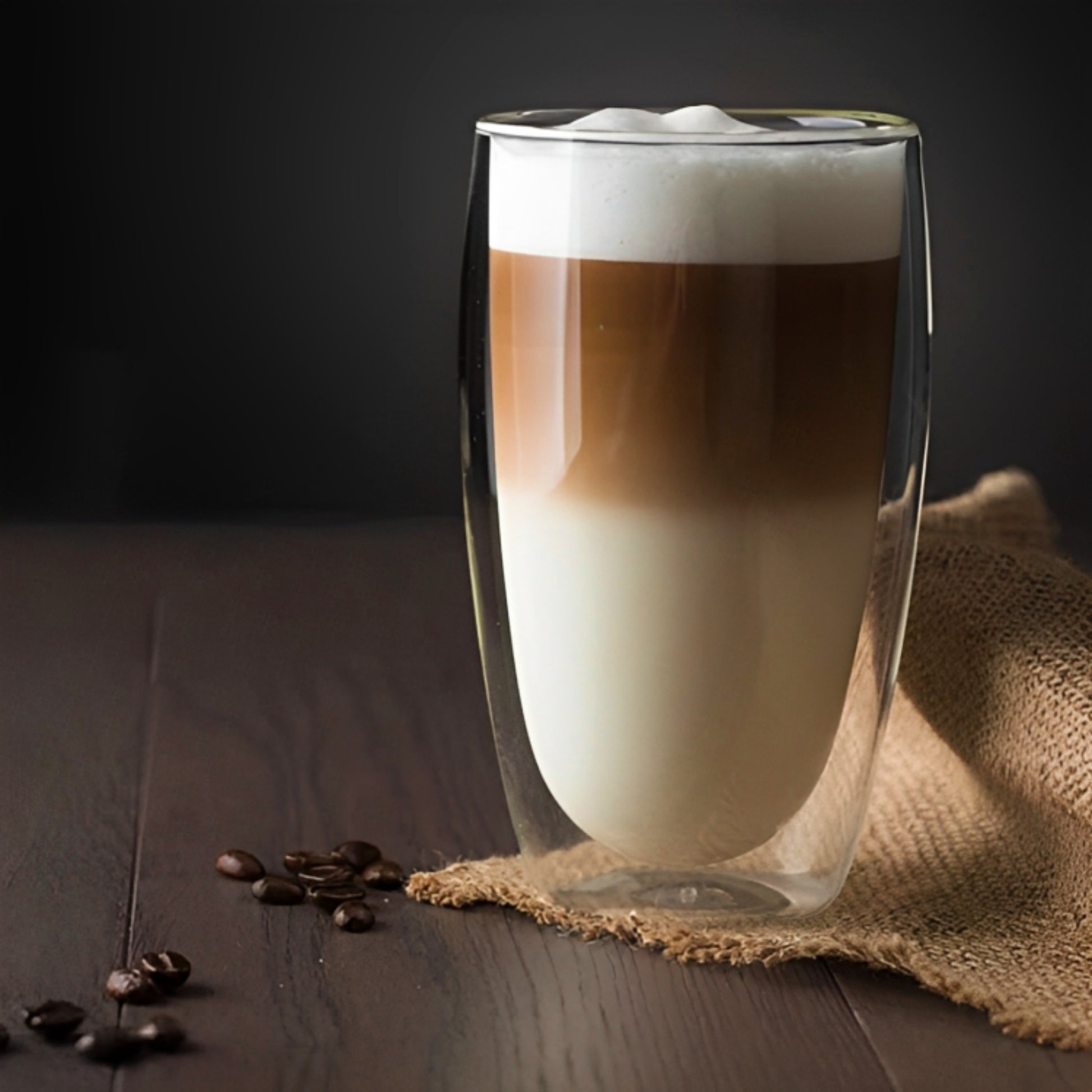 A single double walled glass with layered coffee in it